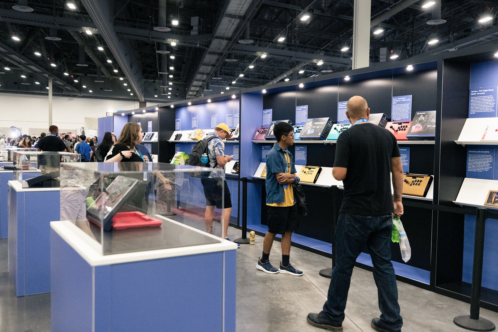 Attendees explore an arcade stick display.