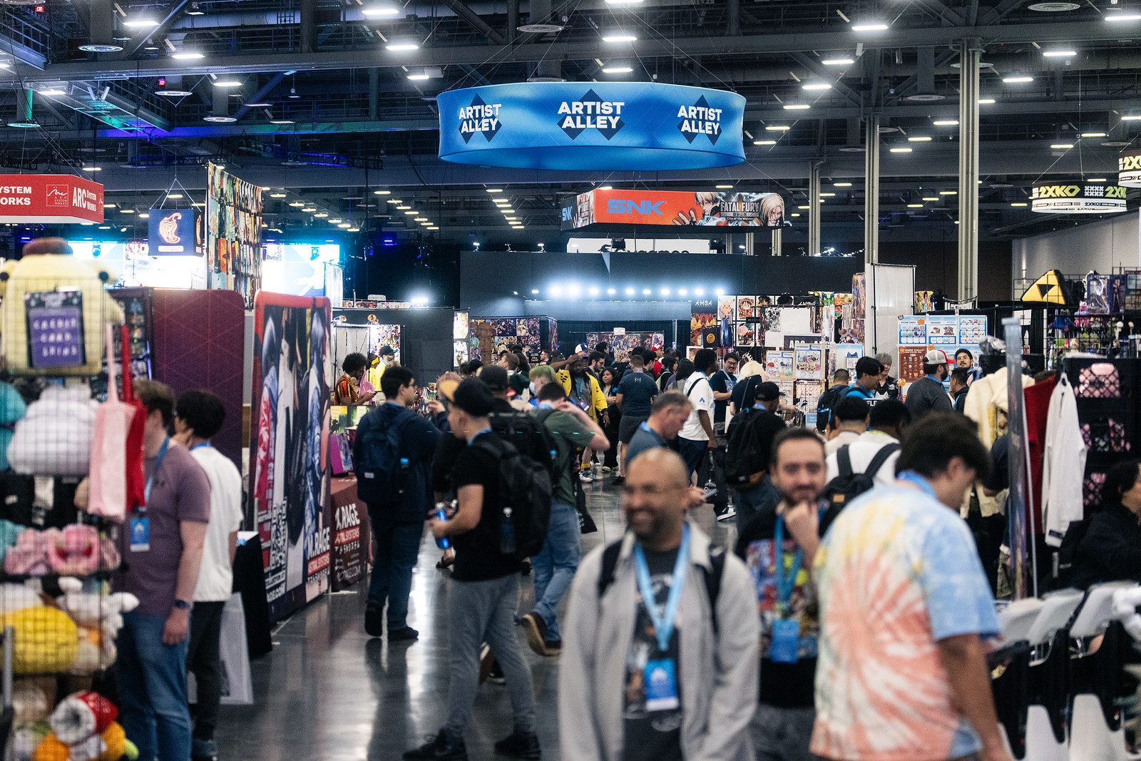 Crowds browse vendors at a busy artist alley.