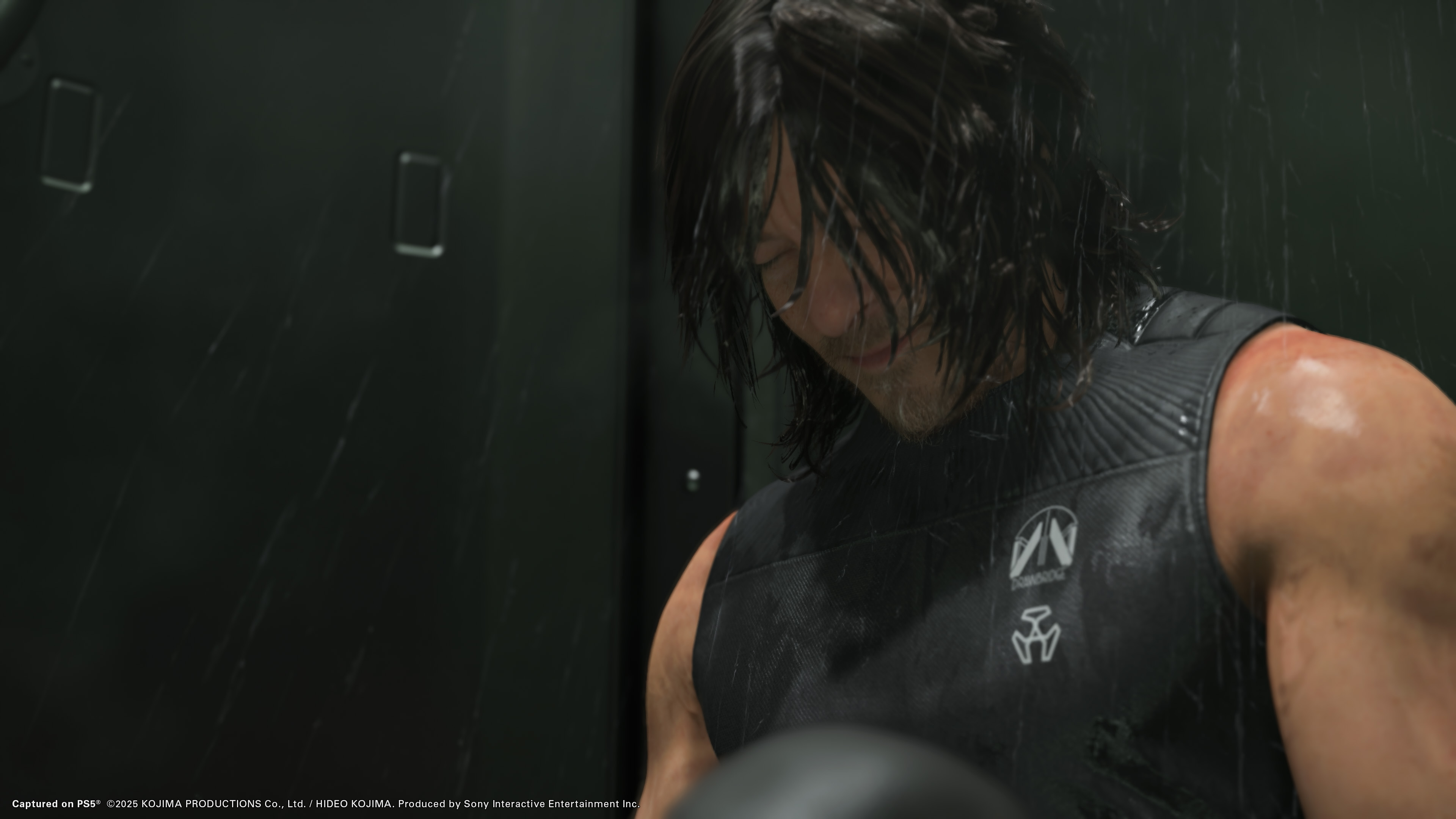 Death Stranding 2: On the Beach screenshot showing Sam up close with his head down